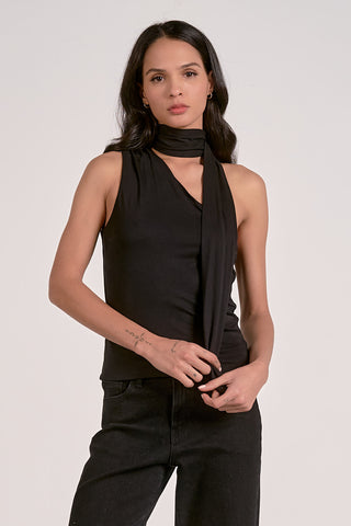 Woman wearing a black sleeveless top and pants with a black scarf on a white background