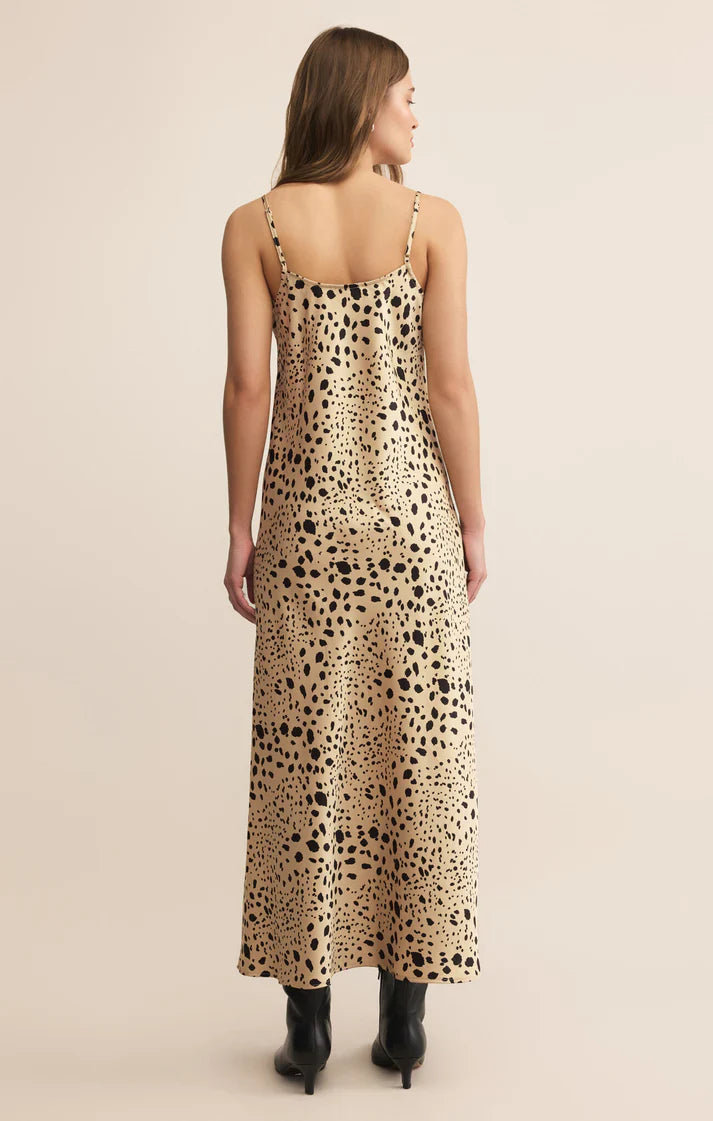 Woman wearing a leopard print dress on a beige background