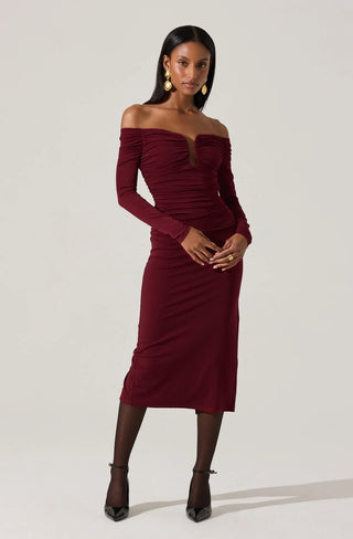 Woman wearing a burgundy off-shoulder dress on a white background