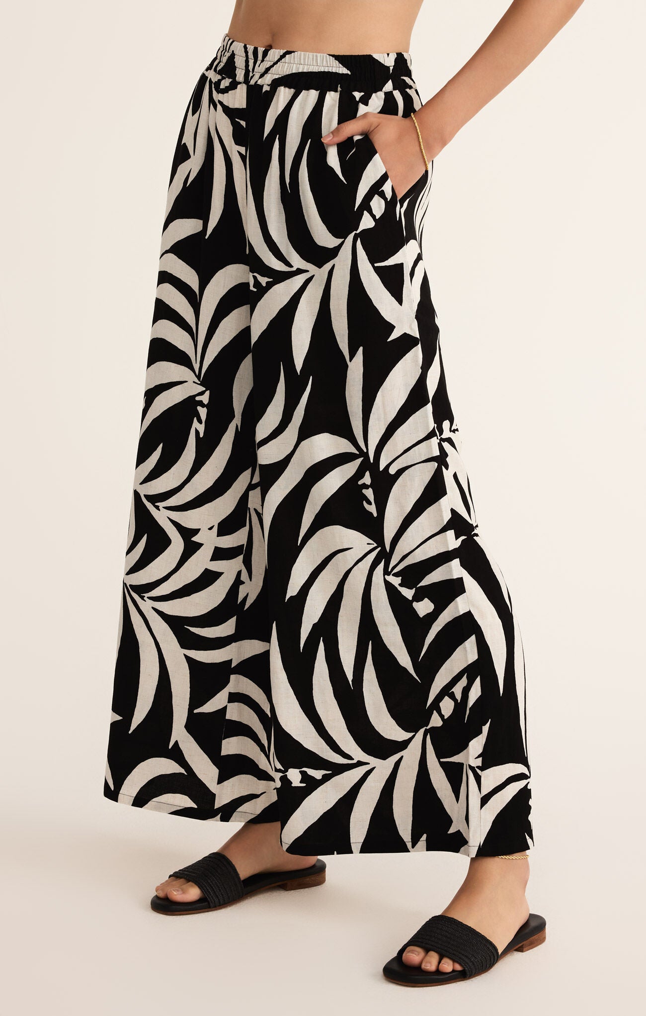 A model wearing black and white tropical palm STMT BOUTIQUE 