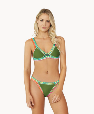 A woman wearing a green, orange, and white geometric patterned bikini STMT BOUTIQUE 