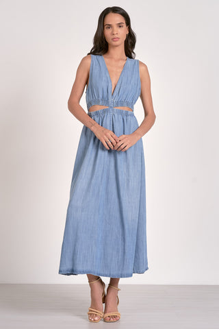 A woman wearing a midi length sleeveless blue dress STMT BOUTIQUE 