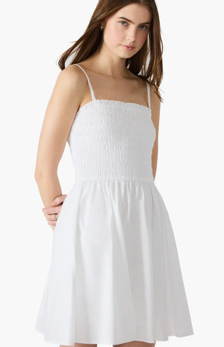 A woman wearing a white sleeveless knee-length dress STMT BOUTIQUE 