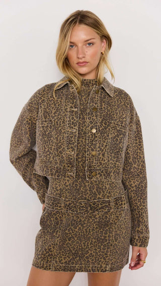 Woman wearing a leopard print dress with a white background