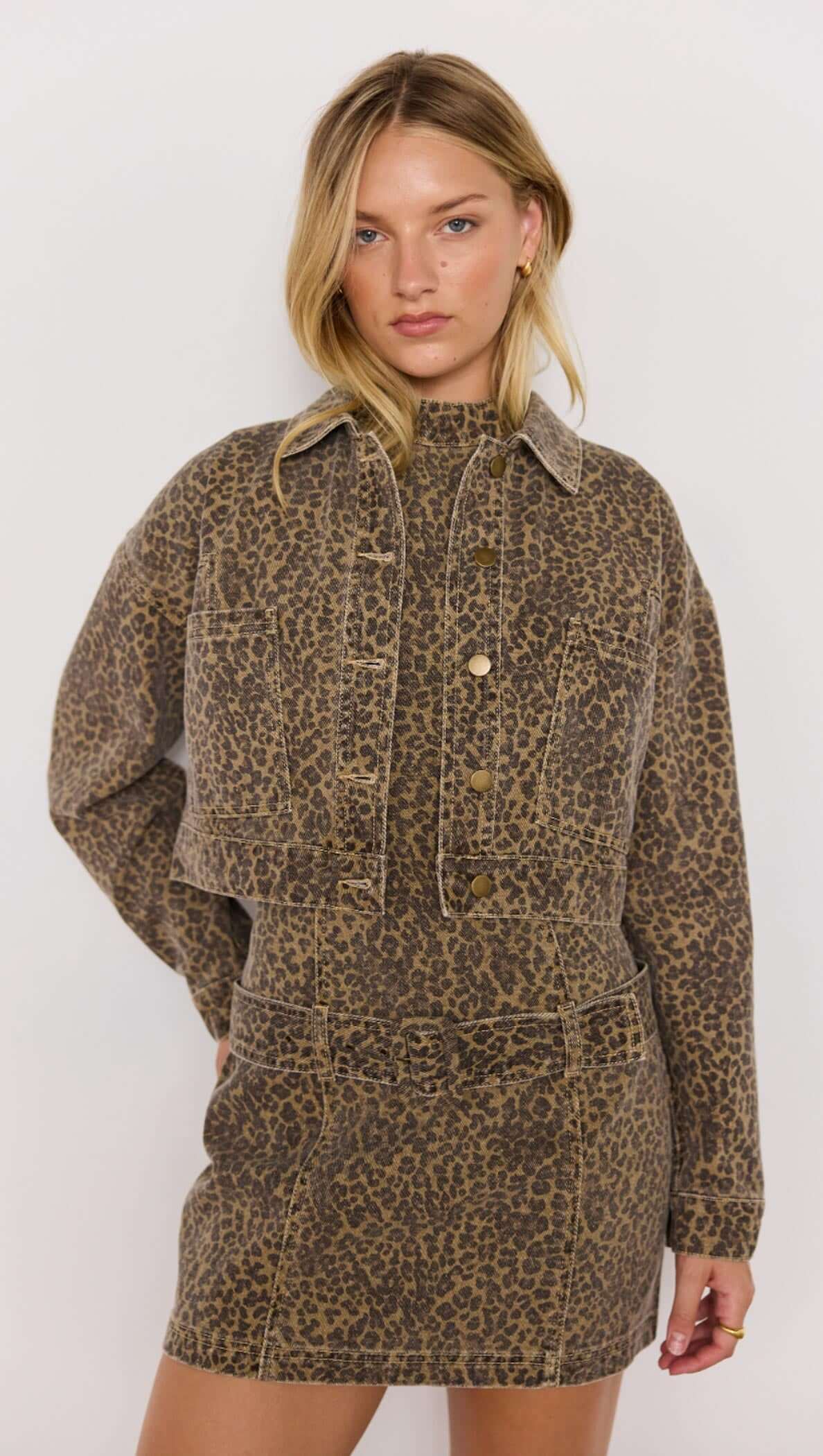 Woman wearing a leopard print dress with a white background