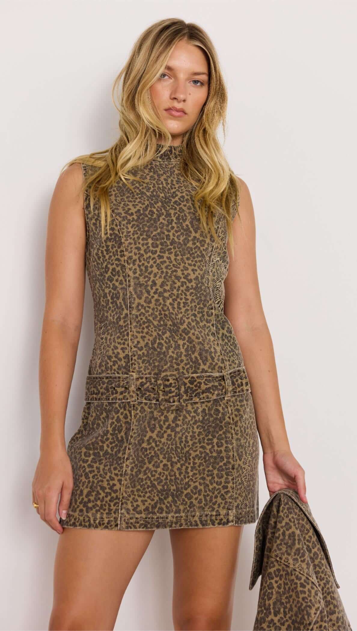 Woman wearing a leopard print dress against a white background
