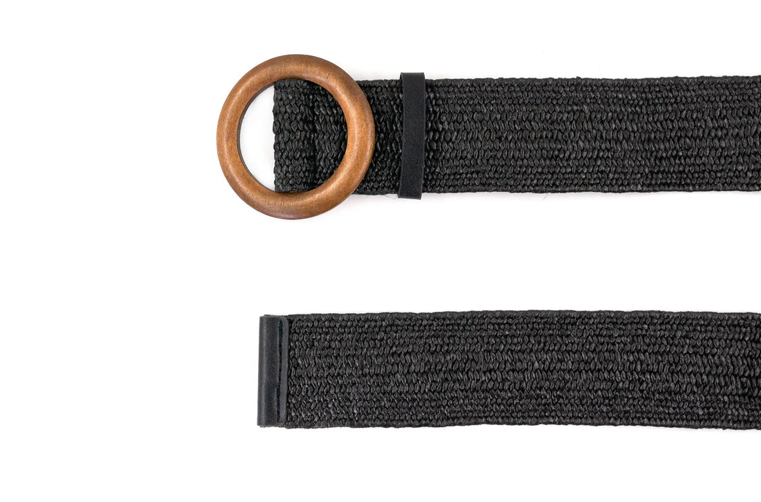 Black belt with a wooden ring on a white background