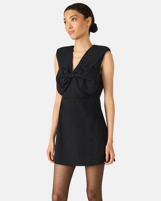 Black dress with a bow detail on a white background