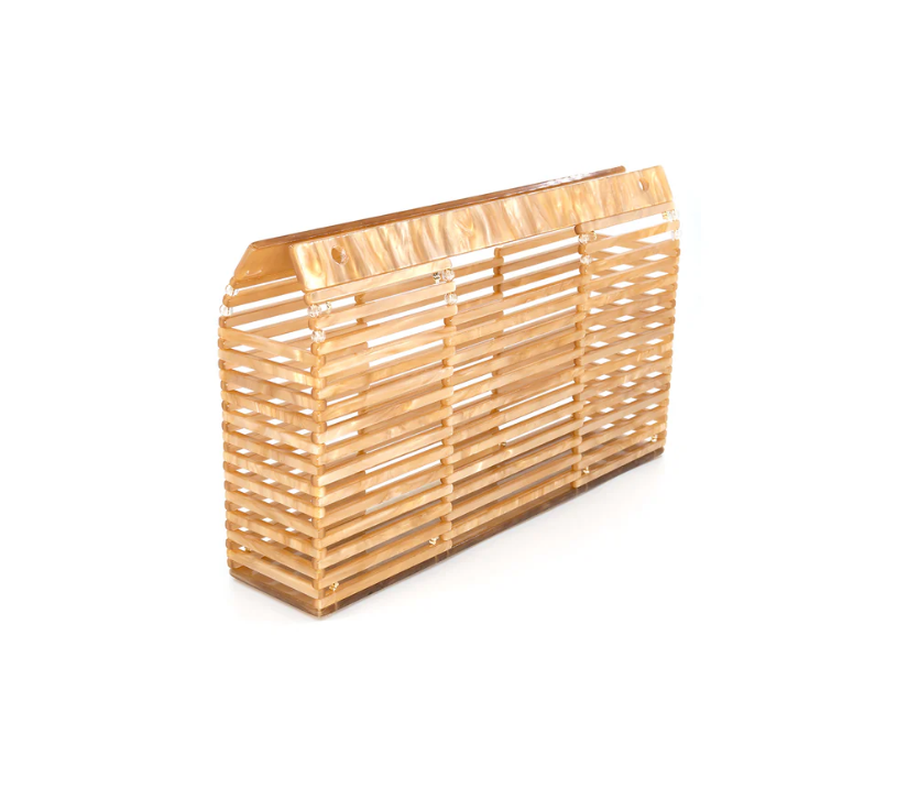 An acrylic clutch with a bamboo-like pattern and a gold chain strap.