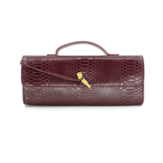 Maroon textured handbag with a gold clasp on a white background