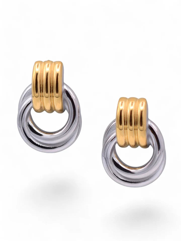 Pair of gold and silver hoop earrings on a white background