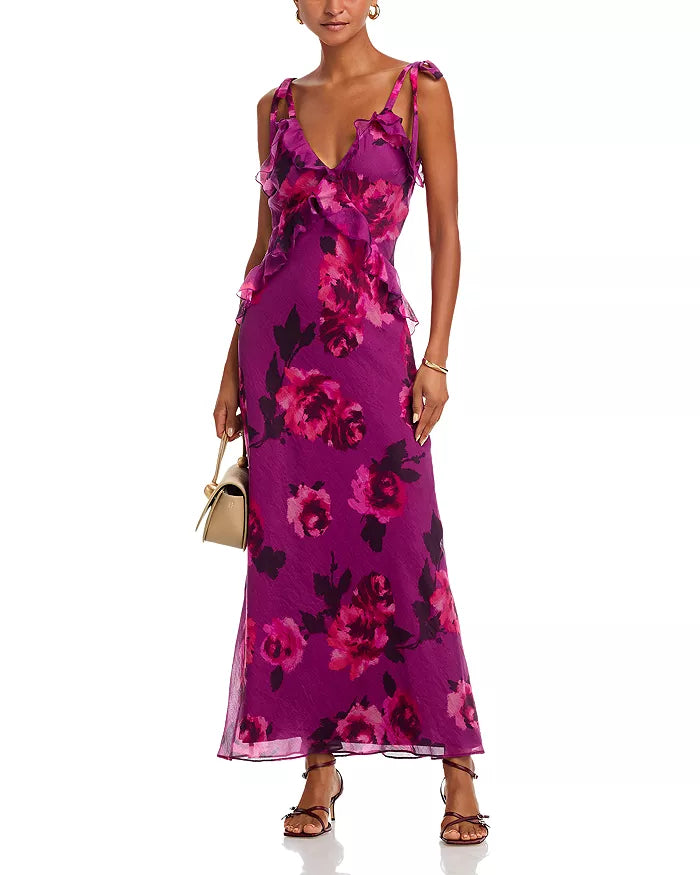 Woman wearing a purple floral dress on a white background