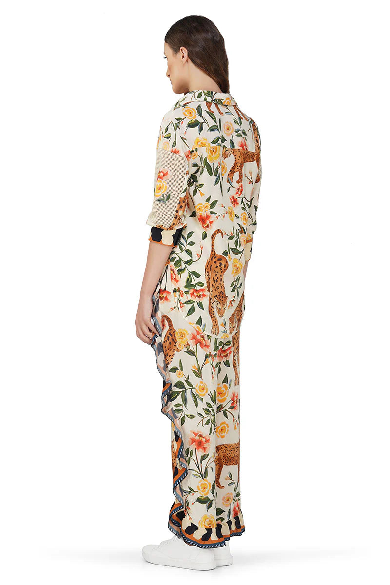 Person wearing a floral and animal print outfit on a white background