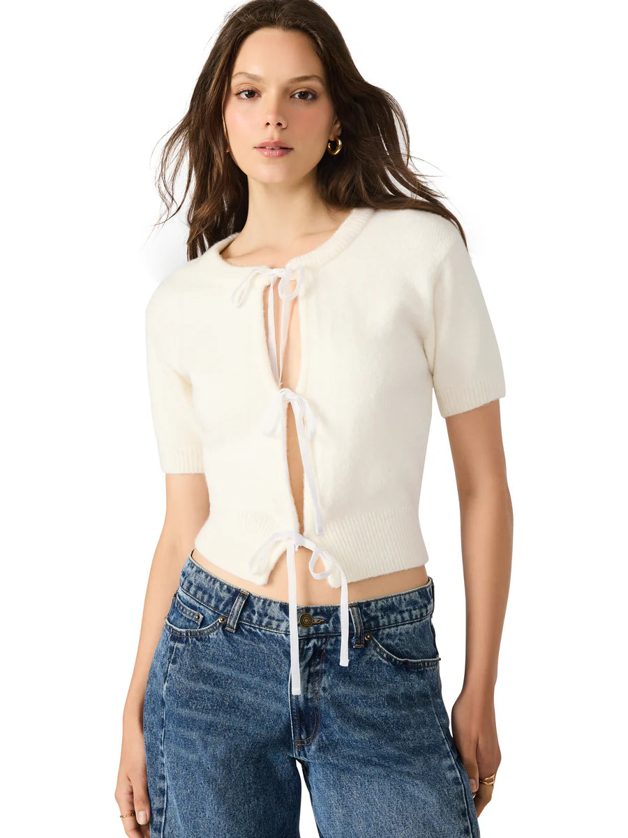 Woman wearing a white top and blue jeans on a white background