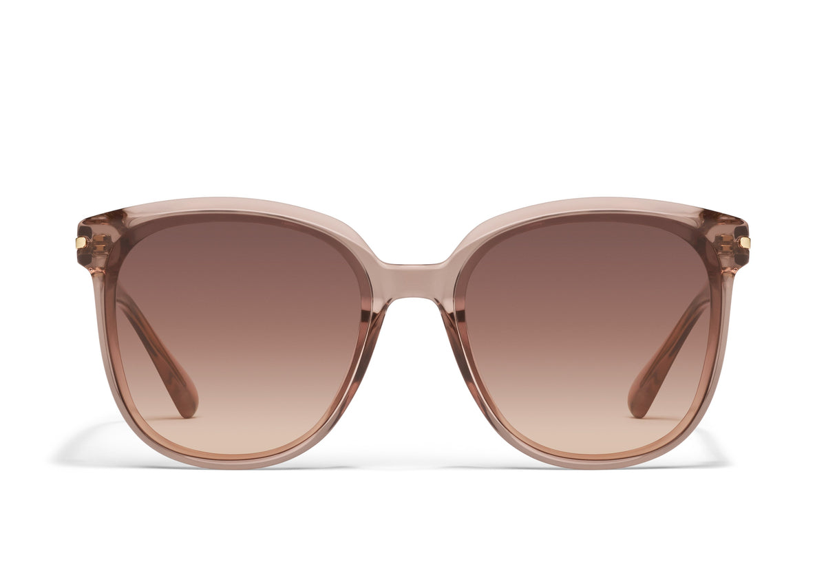 A pair of oversized round sunglasses with a pink frame and clear lenses.