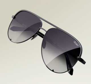 Sunglasses with gradient lenses on a neutral background