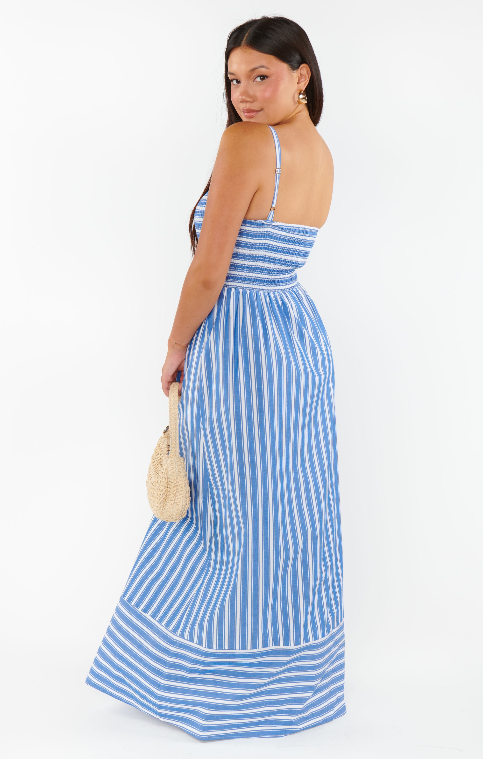 Woman wearing a blue and white striped dress 
