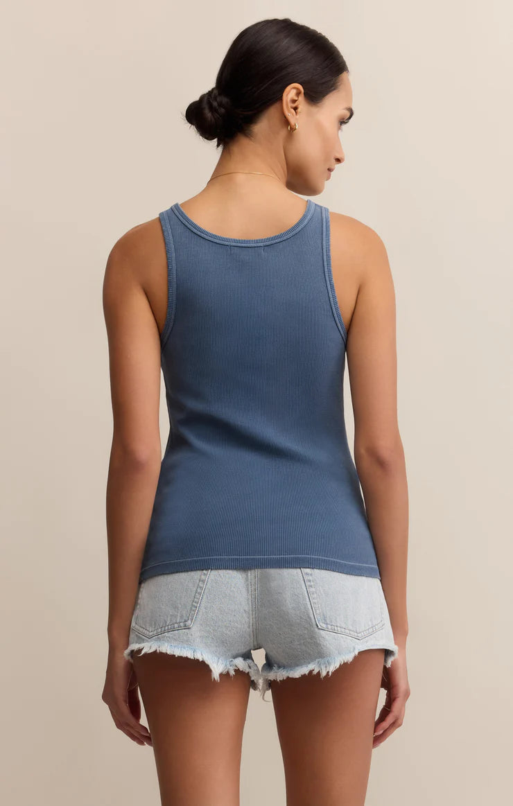 Woman wearing a blue tank top and denim shorts STMT BOUTIQUE 