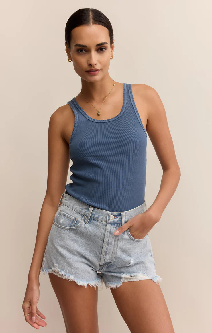 Woman wearing a blue tank top and denim shorts STMT BOUTIQUE 