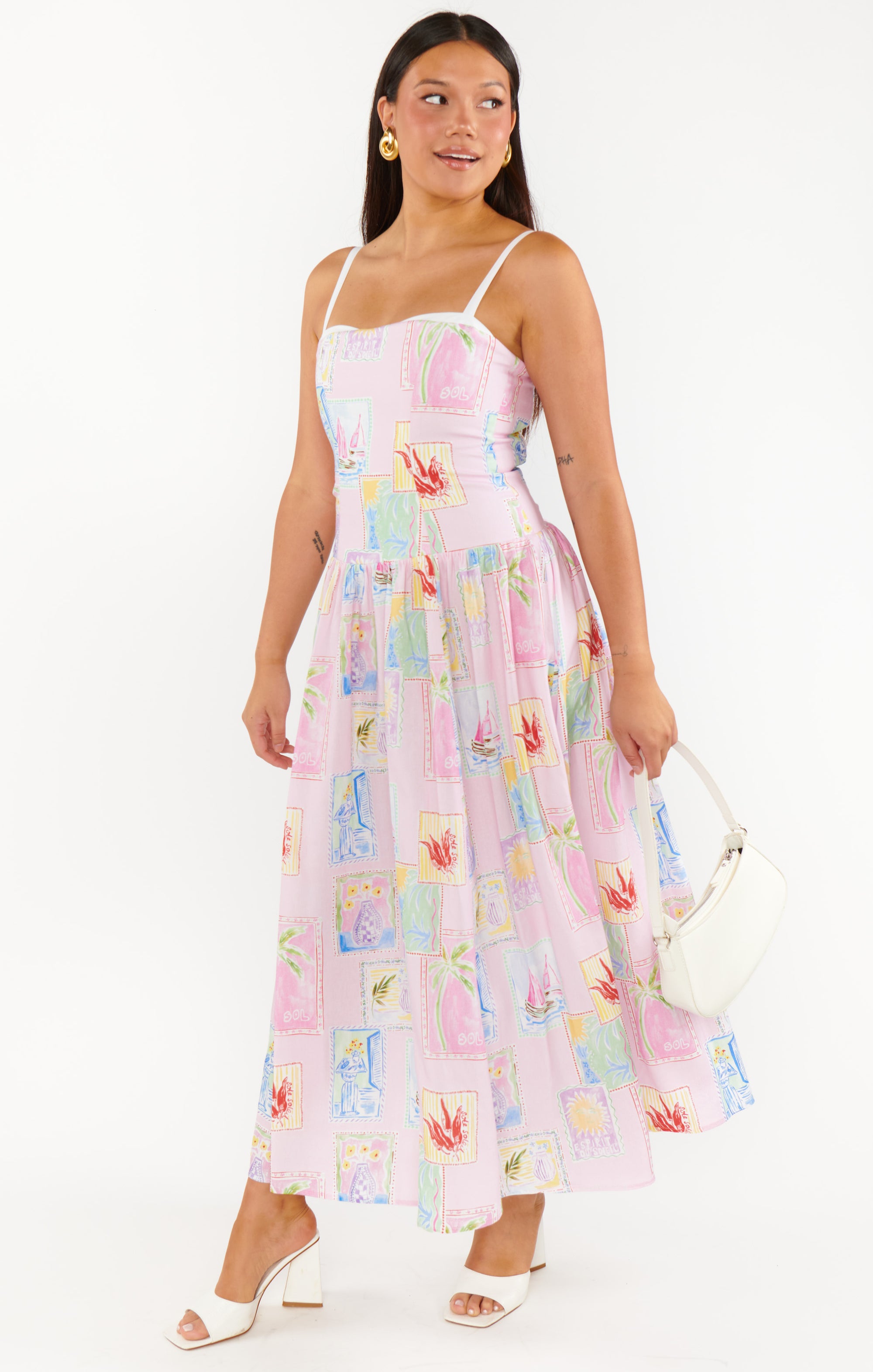 wearing a floral midi dress with a sleeveless design STMT BOUTIQUE 