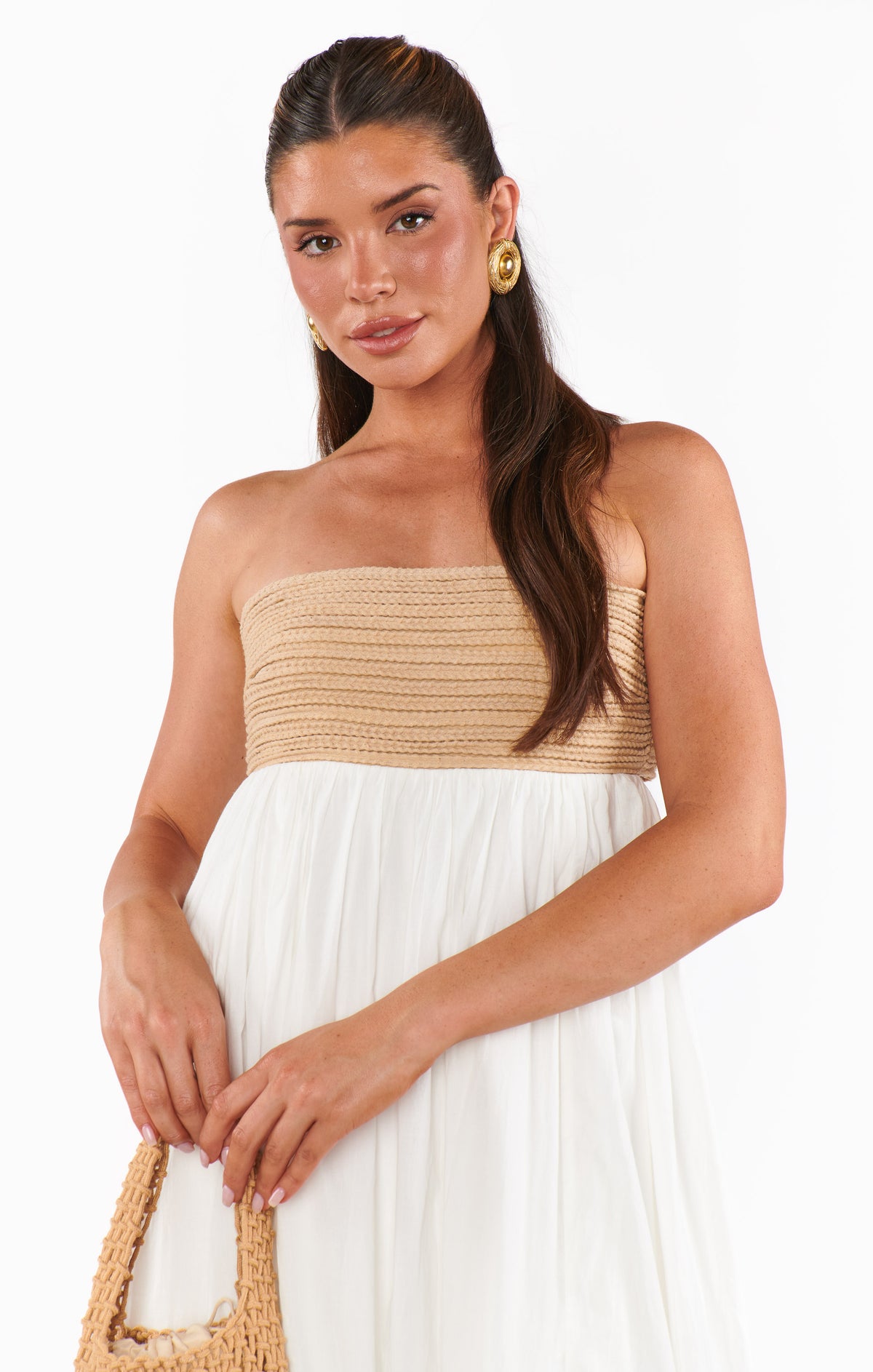 Woman wearing a strapless dress with beige top 