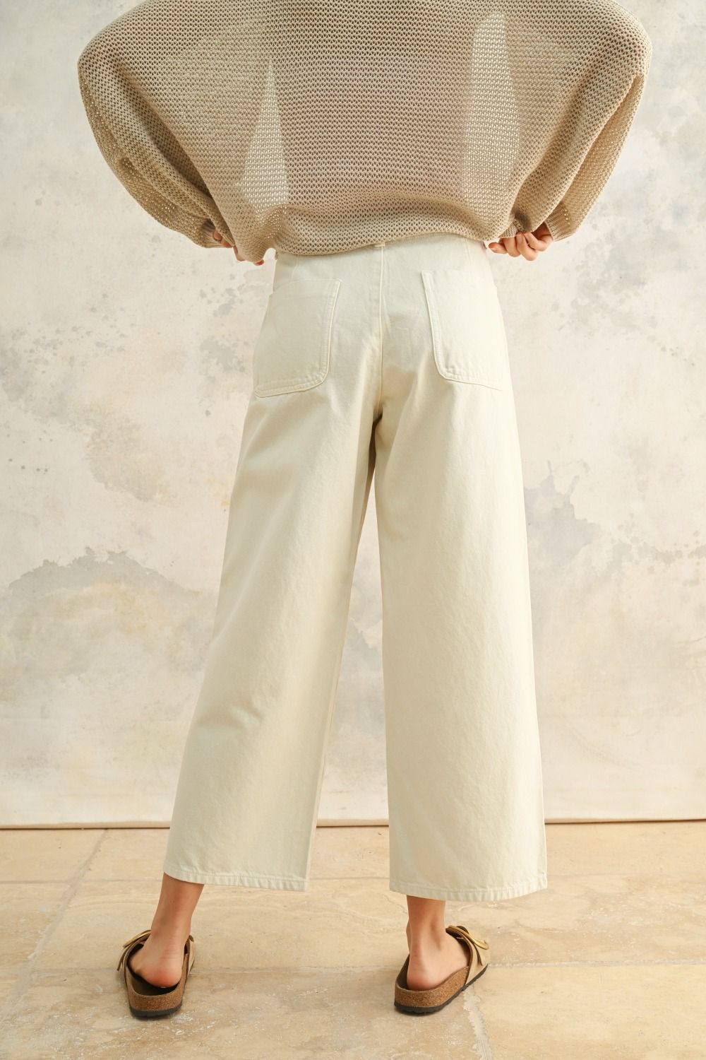 Woman wearing button front cotton pants with blouse 