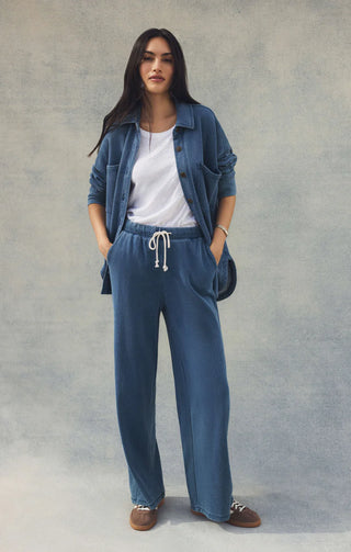 Woman wearing a blue outfit with a white background