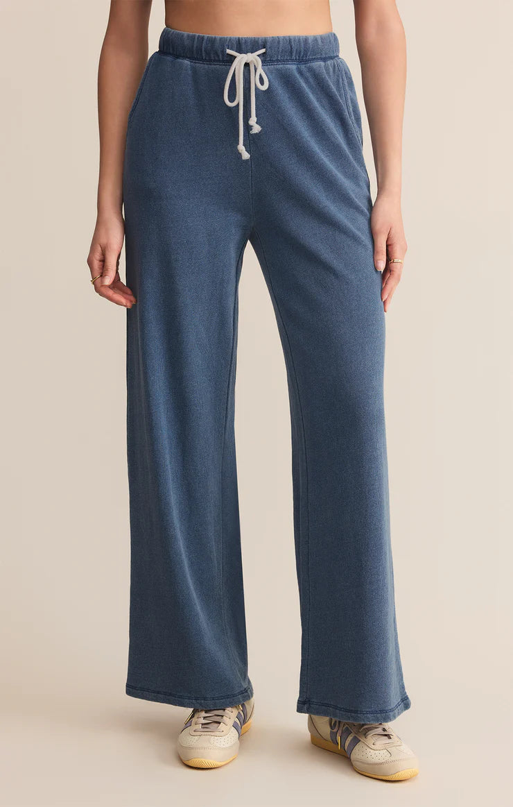 Blue lounge pants with a drawstring on a beige background