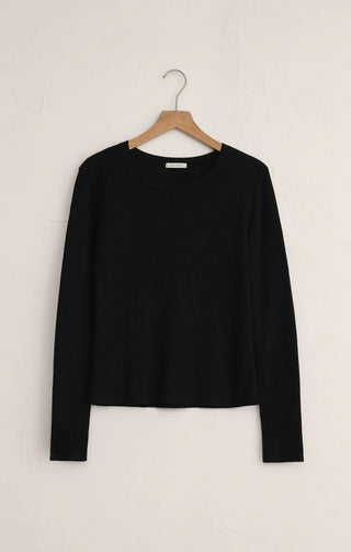 Black long-sleeve shirt on a wooden hanger against a white background