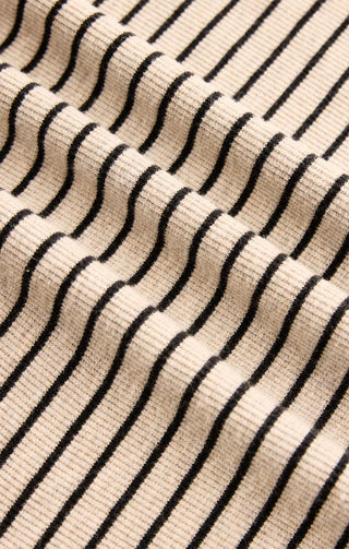 Close-up of a fabric with black wavy lines on a beige background