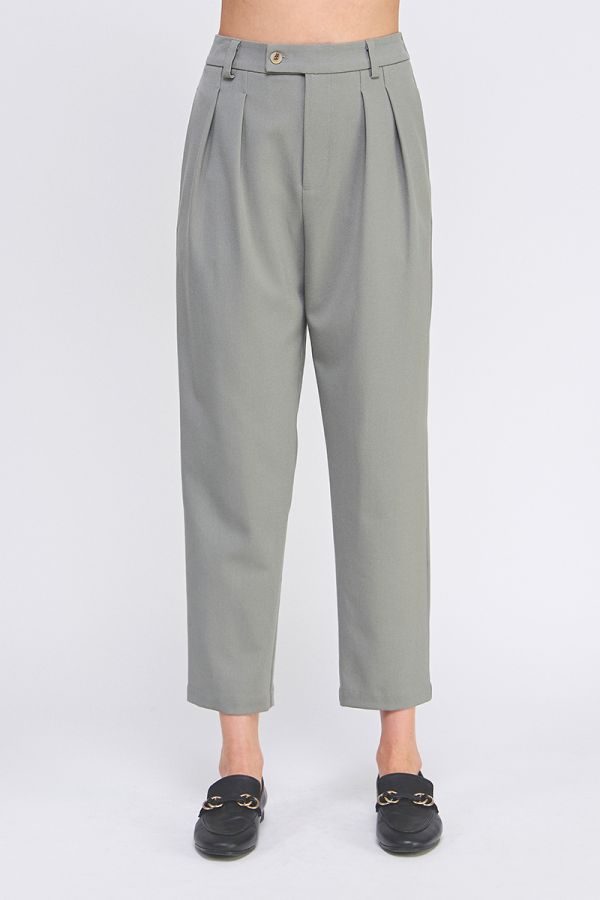 Gray pleated pants worn by a person on a white background