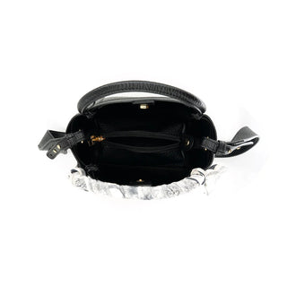 Black handbag with gold accents on a white background