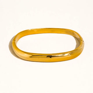 Gold bangle on a white background