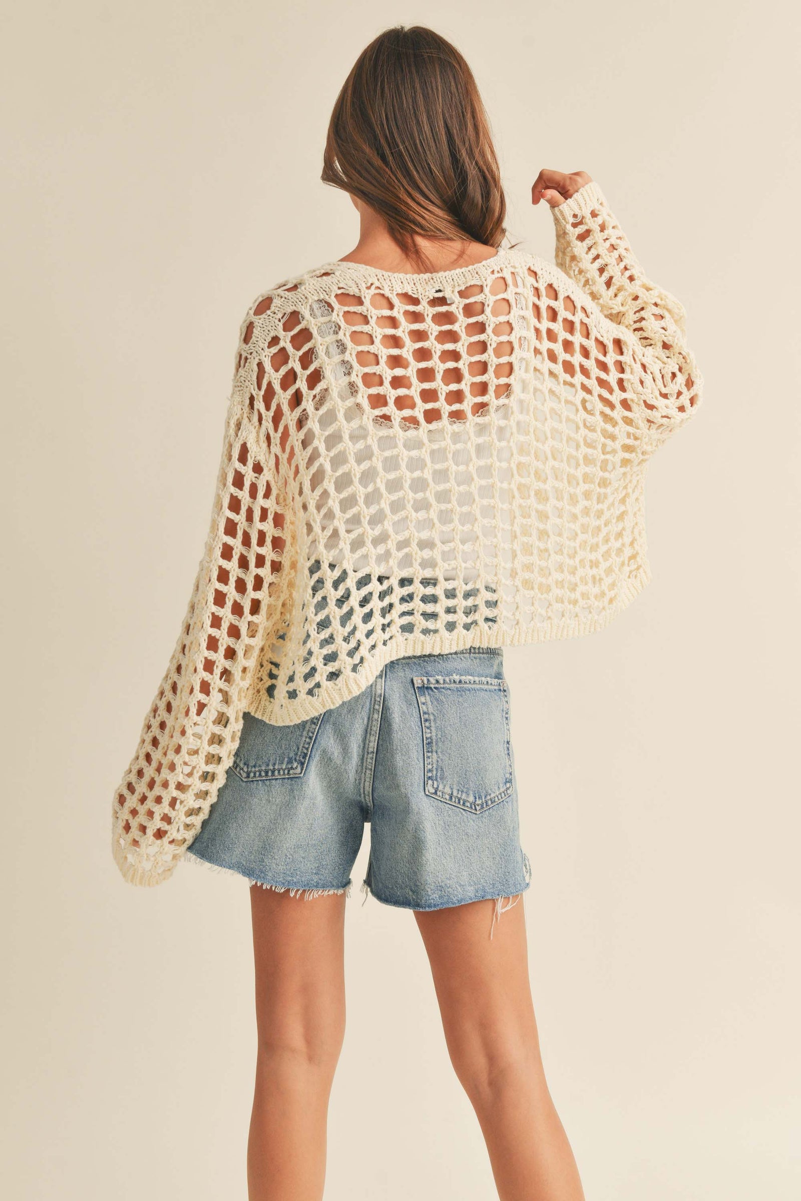  back view showing cropped fit and crochet detailing