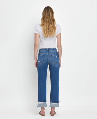 Woman wearing blue jeans and a white t-shirt on a white background