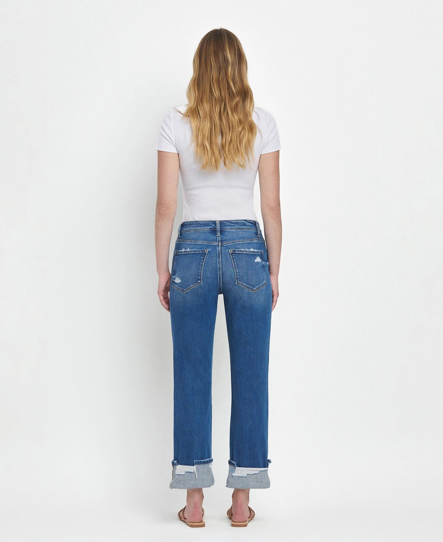 Woman wearing blue jeans and a white t-shirt on a white background