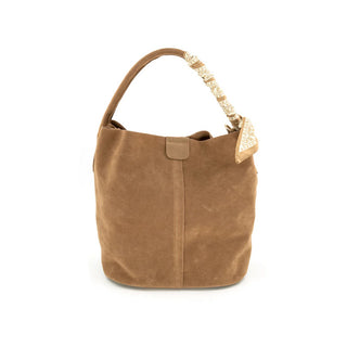 Brown handbag with decorative handle on a white background