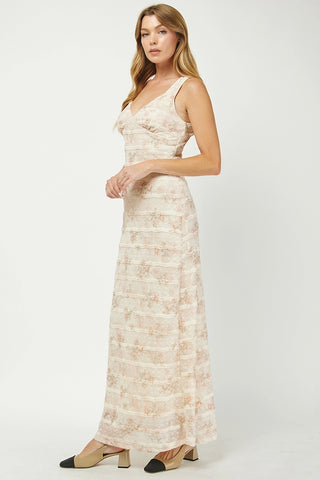 Woman wearing a beige floral dress on a white background