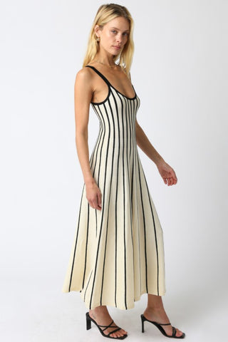 Woman wearing a black and white striped dress on a white background