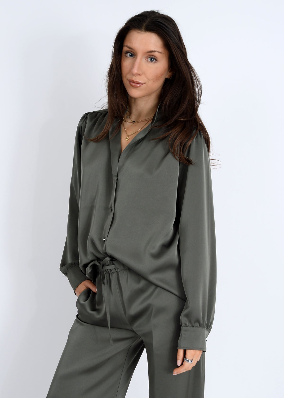 Woman wearing a green outfit on a white background