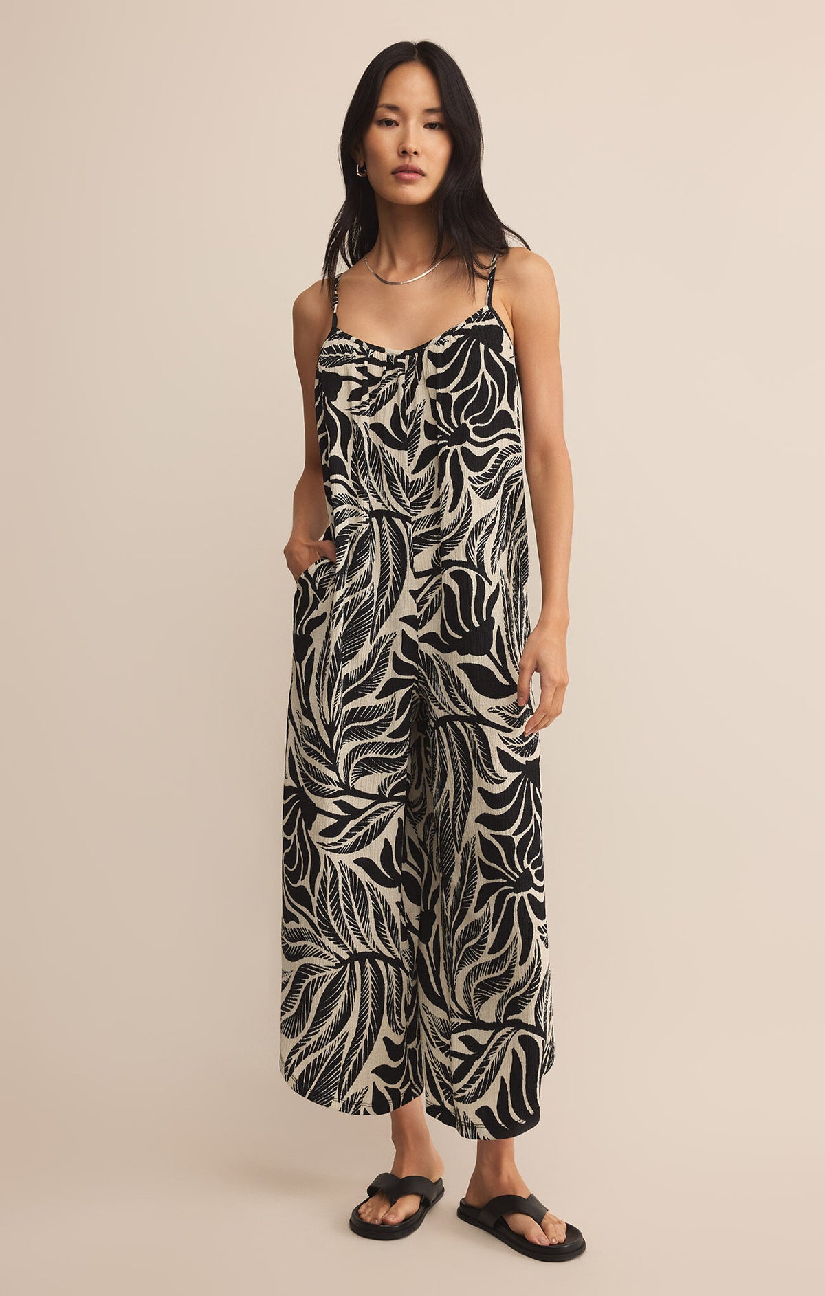 Woman wearing a black and white patterned jumpsuit STMT BOUTIQUE 