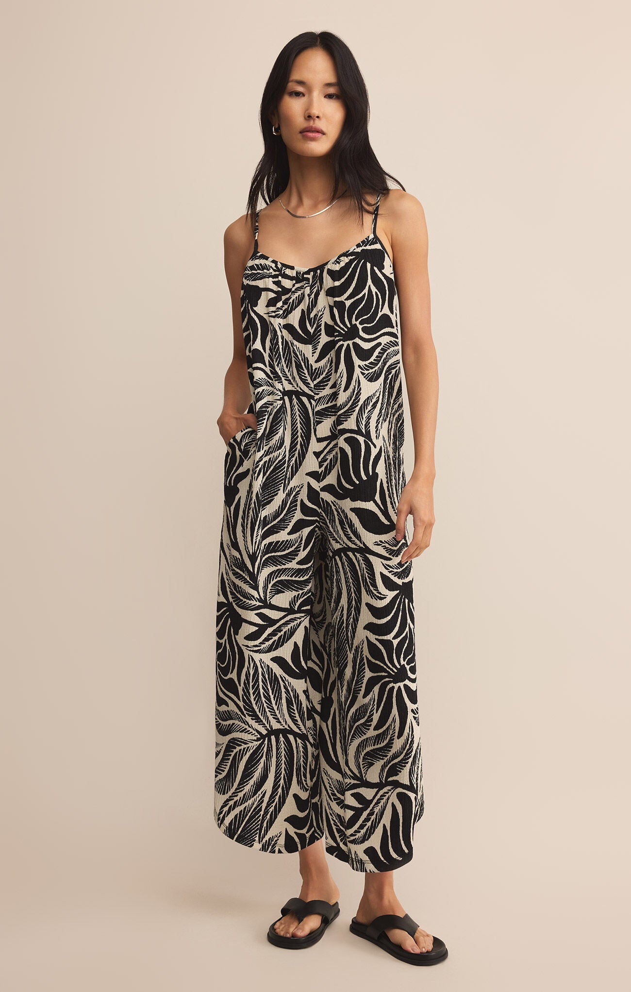 Woman wearing a black and white patterned jumpsuit STMT BOUTIQUE 