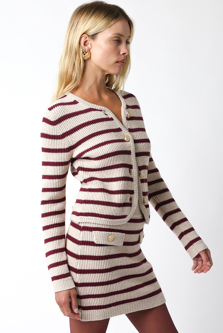 Woman wearing a striped knit outfit on a white background