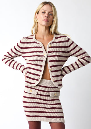 Woman wearing a striped knit outfit on a white background