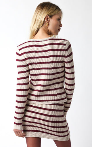 Woman wearing a striped sweater dress on a white background