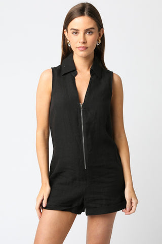 Woman wearing a black sleeveless romper on a white background