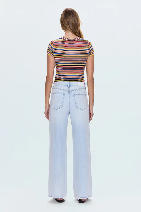 Person wearing a striped shirt and light blue jeans on a white background