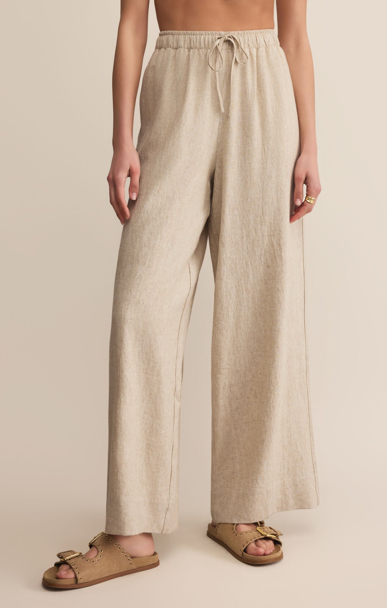Beige linen pants worn by a person STMT BOUTIQUE 