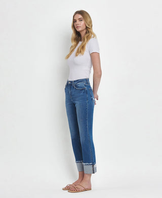 Woman wearing a white t-shirt and blue jeans on a white background