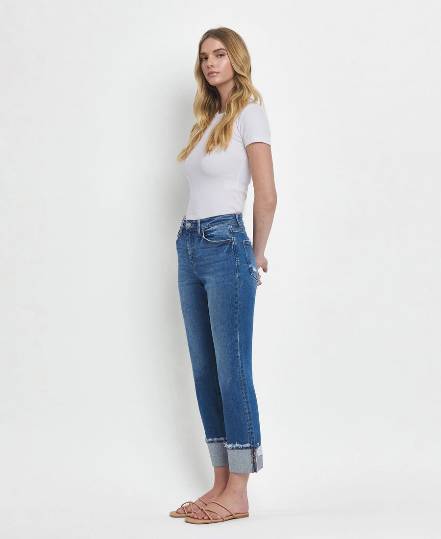 Woman wearing a white t-shirt and blue jeans on a white background